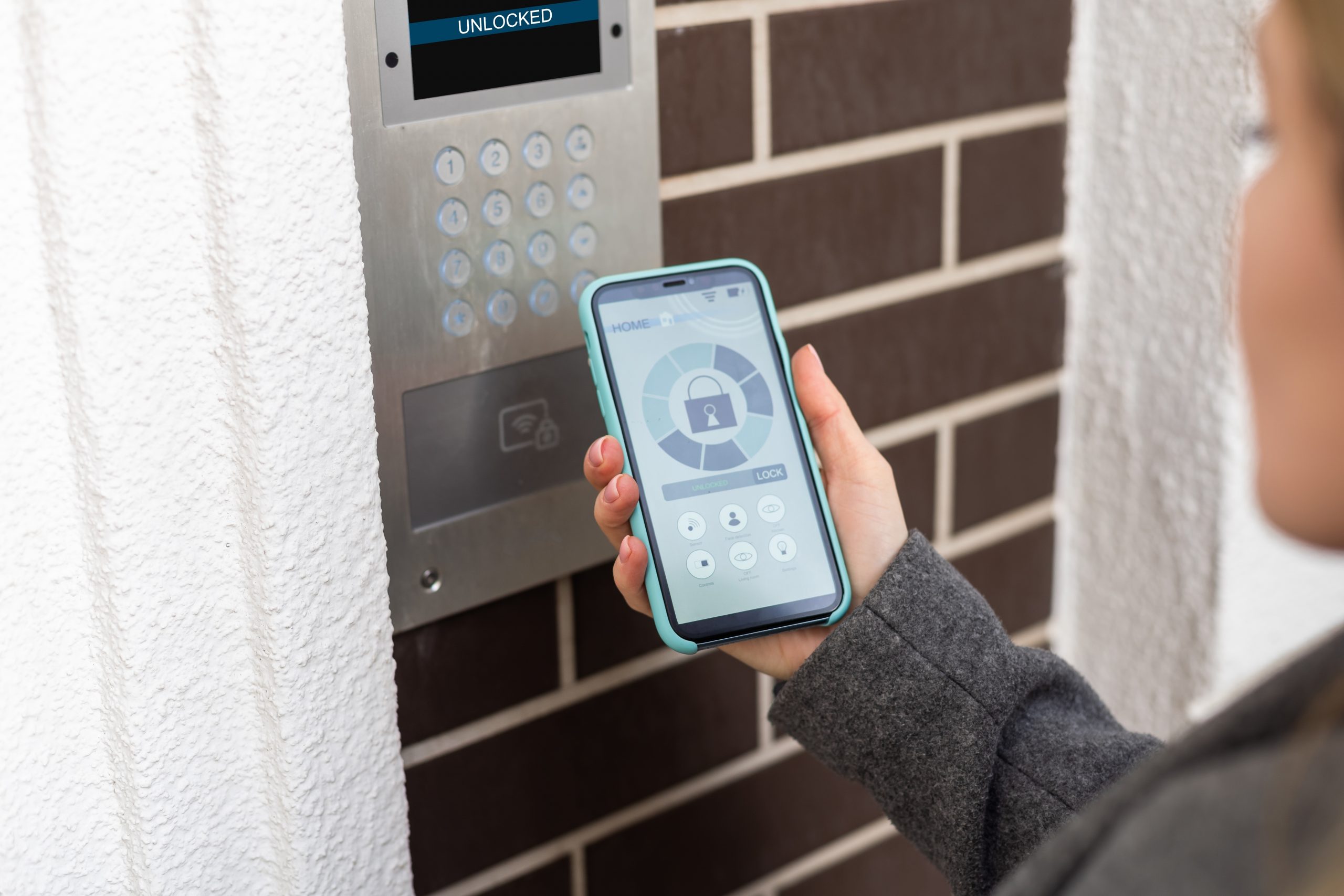 Smiling,Woman,Setting,Home,Security,System,With,Help,Of,Mobile